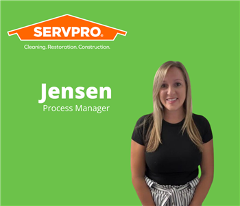 female employee standing in front of green background with servpro logo