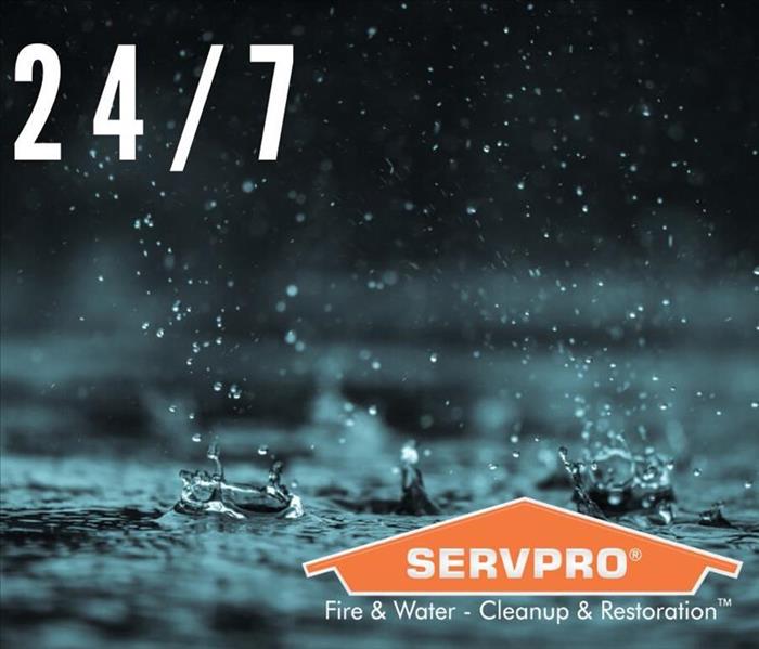 Pouring rain and text that says 24/7 with SERVPRO logo