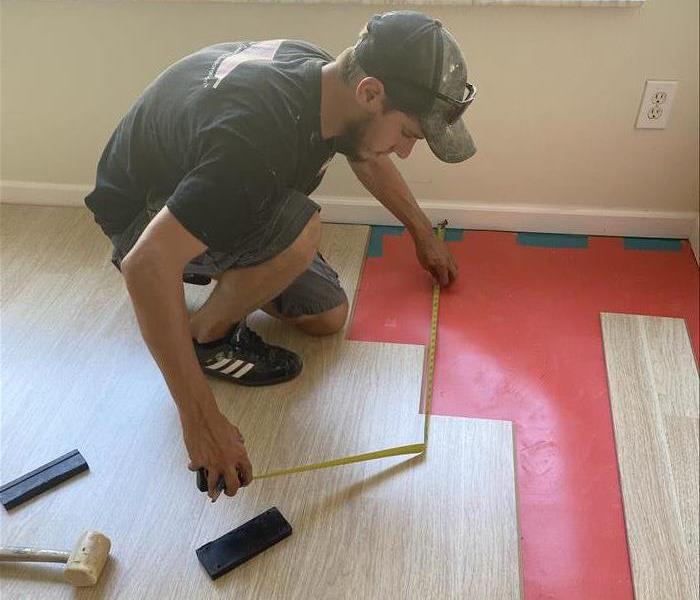 SERVPRO employee measuring new flooring