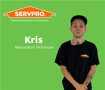 male servpro water damage restoration technician with green background and servpro logo